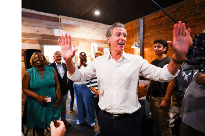 California Gov. Gavin Newsom shakes an attendee's hand during a visit to an event center in Pickens, South Carolina California Gov. Gavin Newsom shakes an attendee's hand during a visit to an event center in Pickens, South Carolina